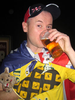 Bryan draped with Aussie flag, in an Aussie tshirt, wearing an Aussie oven glove, hat, and stuffed kangaroo