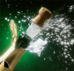 Champagne cork popping with a gush of celebratory bubbles