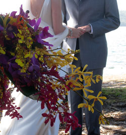 A bouquet of orchids, Emma and James in the background