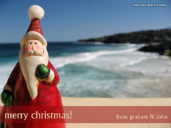 A Father Christmas figure with Tamarama Beach in the background